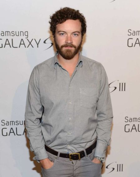 Danny Masterson in a grey t-shirt poses a picture..